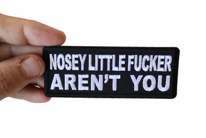 Nosey Little Fucker Aren't You Funny Iron on Patch shown on hand for size comparison