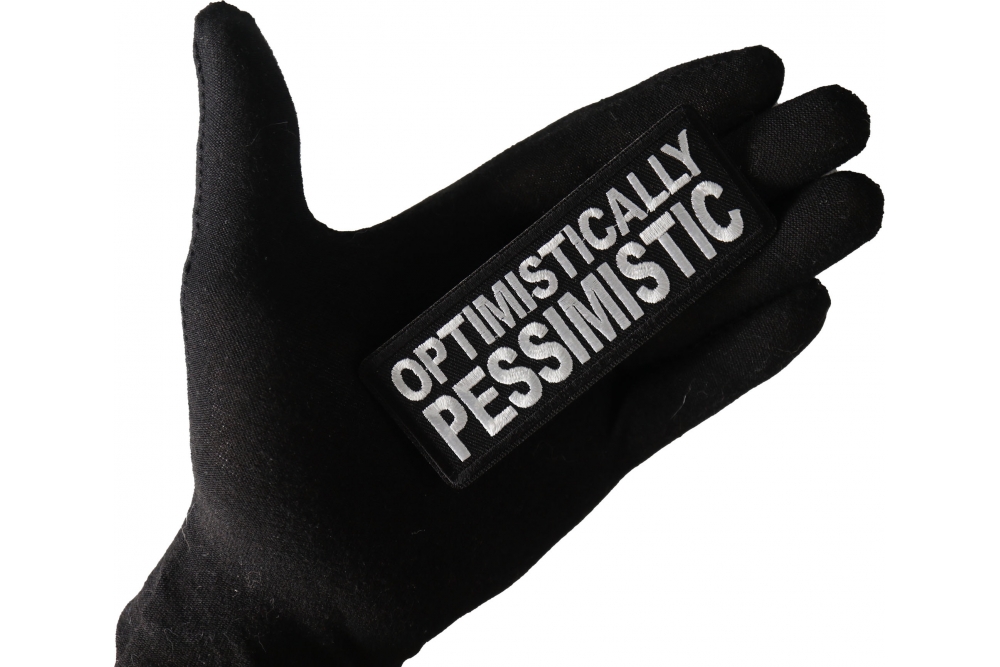 Optimistically Pessimistic Funny Iron on Patch shown on hand for size comparison