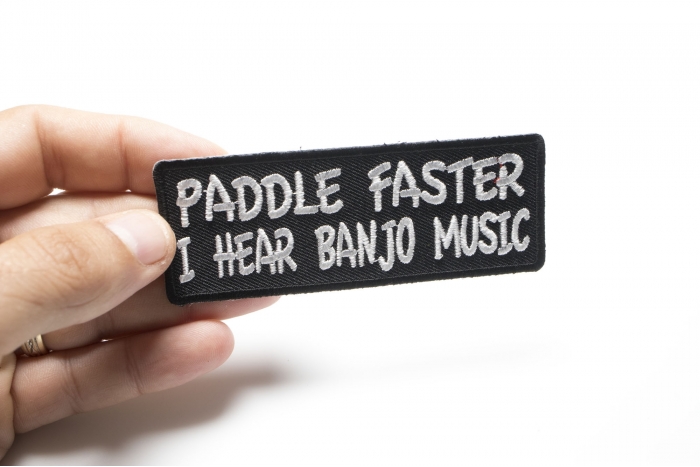 Paddle Faster I Hear Banjo Music Funny Iron on Patch shown on hand for size comparison