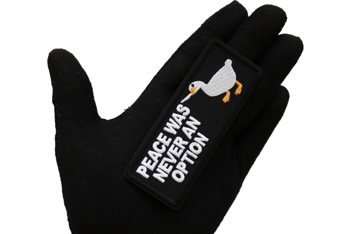 Peace Was Never an Option Duck with Knife Iron on Patch shown on hand for size comparison