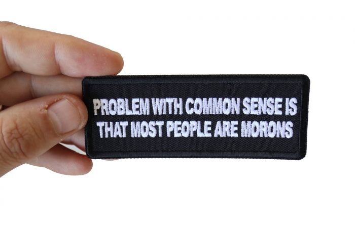 Problem with Common Sense is that most people are Morons Funny Iron on Patch shown on hand for size comparison