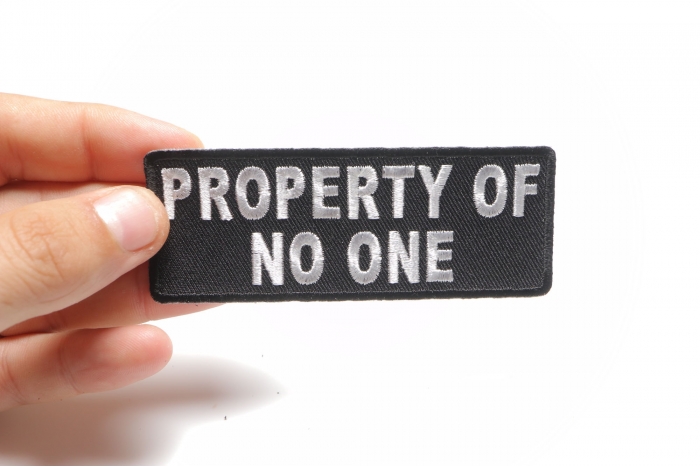 Property Of No One Funny Iron on Patch shown on hand for size comparison