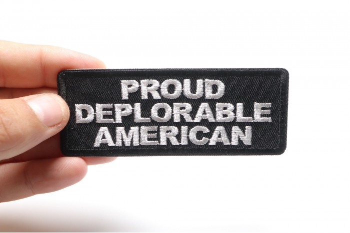Proud Deplorable American Funny Iron on Patch shown on hand for size comparison