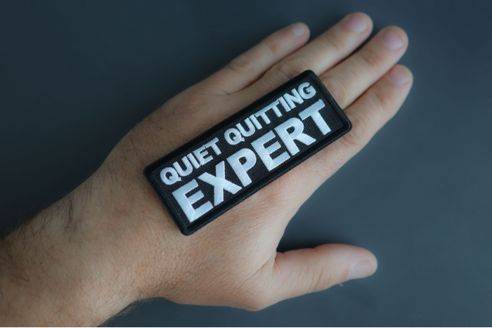 Quiet Quitting Expert Patch shown on hand for size comparison