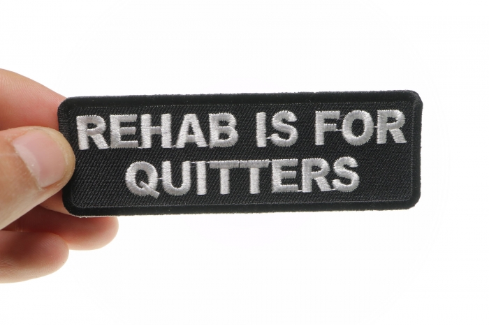 Rehab Is For Quitters Funny Iron on Patch shown on hand for size comparison