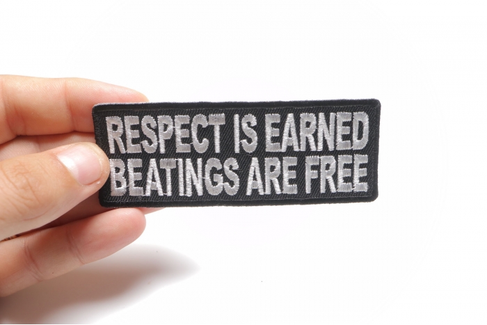 Respect Is Earned Beatings Are Free Funny Patch shown on hand for size comparison