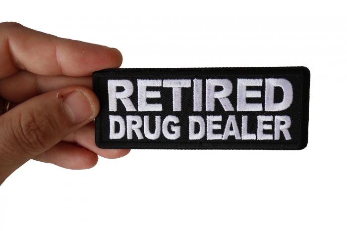 Retired Drug Dealer Funny Iron on Patch shown on hand for size comparison