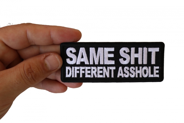 Same Shit Different Asshole Funny Iron on Patch shown on hand for size comparison