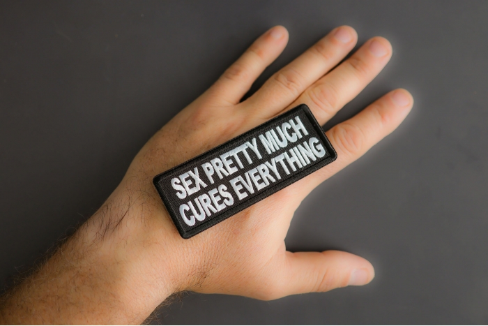 Sex Pretty Much Cures Everything Patch shown on hand for size comparison