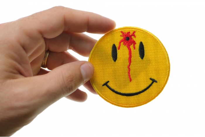 Shot Smiley Funny Iron on Patch shown on hand for size comparison