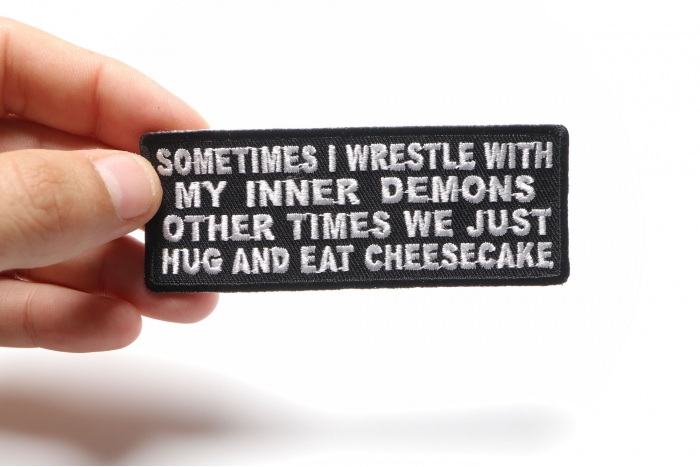 Sometimes I Wrestle With My Inner Demons Other Times We Just Hug and Eat Cheesecake Patch, Funny Saying Patches shown on hand for size comparison