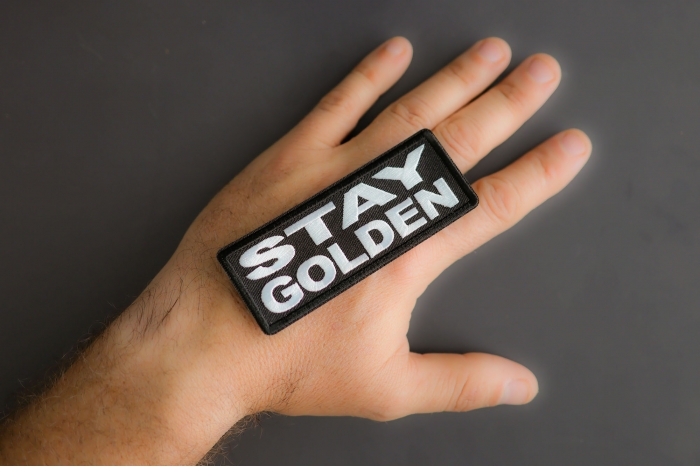 Stay Golden Patch shown on hand for size comparison