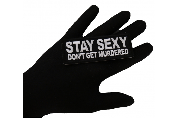 Stay Sext Don't Get Murdered Iron on Funny Iron on Patch shown on hand for size comparison