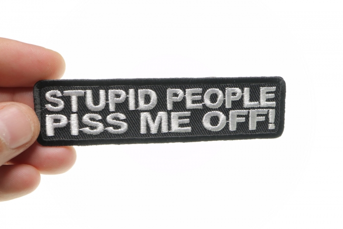 Stupid People Piss Me Off Funny Iron on Patch shown on hand for size comparison