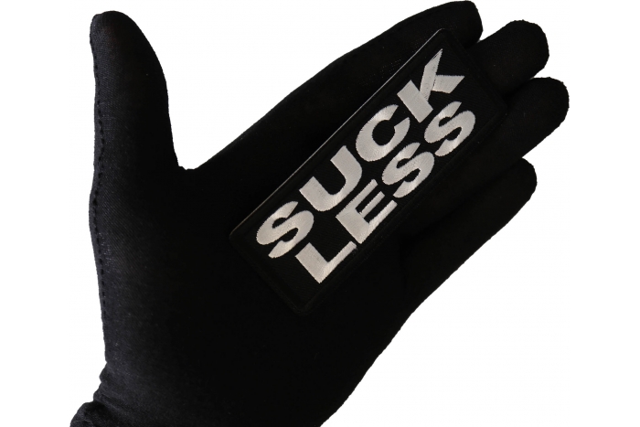 Suck Less Funny Iron on Patch shown on hand for size comparison