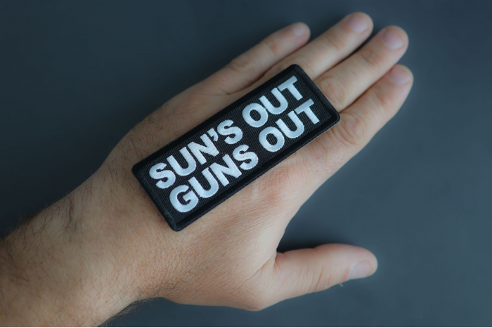 Sun's Out Guns Out Patch shown on hand for size comparison