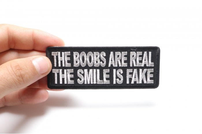 The Boobs are Real The Smile is Fake Patch, Funny Saying Patches shown on hand for size comparison