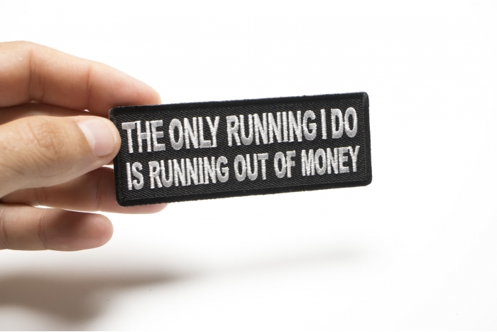 The Only Running I do is Running Out of Money Funny Iron on Patch shown on hand for size comparison