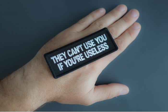 They Cant Use You If You're Useless Patch shown on hand for size comparison