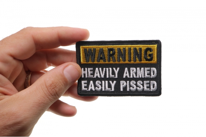 Warning Heavily Armed Easily Pissed Funny Iron on Patch shown on hand for size comparison
