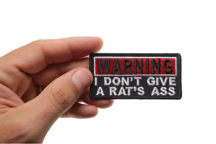 Warning I Don't Give A Rats Ass Funny Iron on Patch shown on hand for size comparison