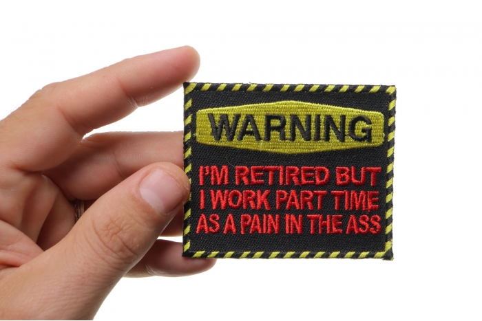 Warning Retired Part Time Pain In The Ass Funny Iron on Patch shown on hand for size comparison