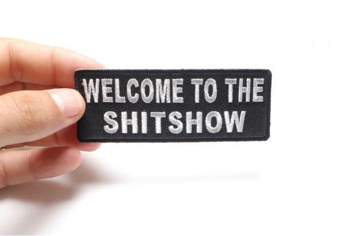Welcome To The ShitShow Fun Funny Iron on Patch shown on hand for size comparison