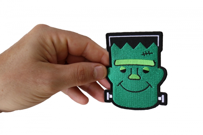 Whacky Frankenstein Funny Iron on Patch shown on hand for size comparison