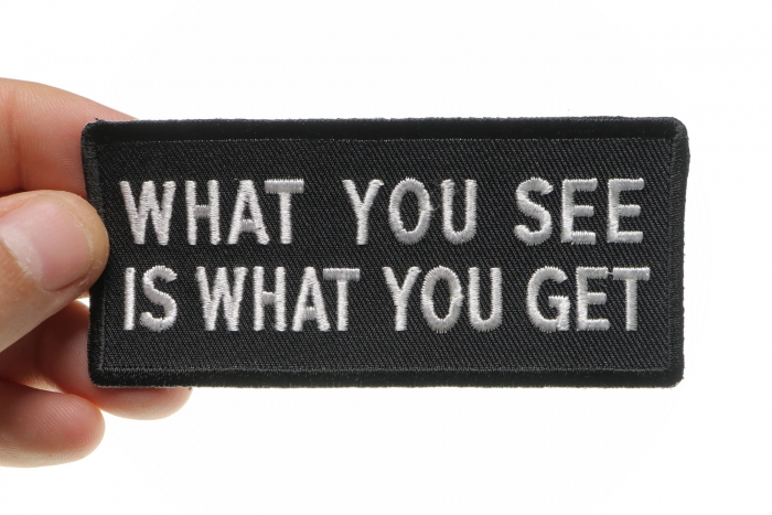 What You See Is What You Get Funny Iron on Patch shown on hand for size comparison