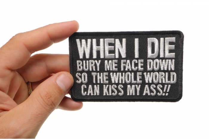 When I Die Bury Me Face Down So The Whole World Can Kiss My Ass Funny Iron on Patch shown on hand for size comparison