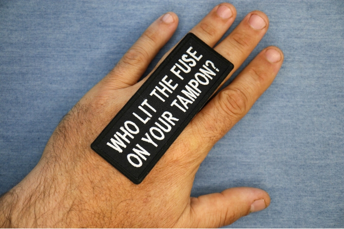 Who Lit The Fuse On Your Tampon Funny Iron on Patch shown on hand for size comparison