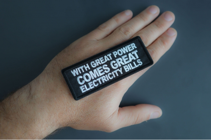 With Great Power Comes Great Electricity Bills Patch shown on hand for size comparison