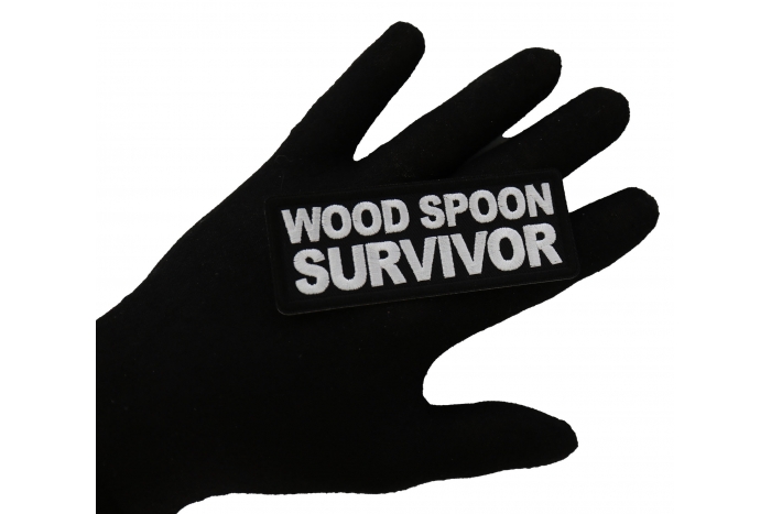 Wood Spoon Survivor Funny Iron on Patch shown on hand for size comparison
