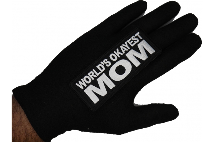 World's Okayest Mom Patch shown on hand for size comparison
