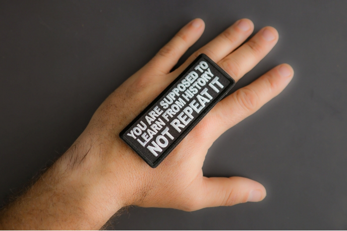 You Are Supposed To Learn From History Not Repeat It Patch shown on hand for size comparison