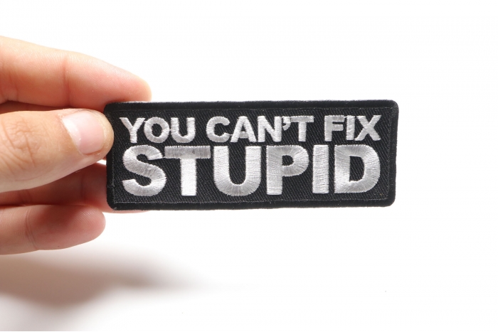 You Can't Fix Stupid Patch, Biker Sayings shown on hand for size comparison