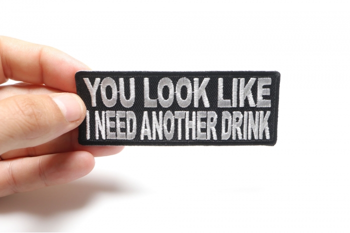 You Look Like I Need Another Drink Funny Iron on Patch shown on hand for size comparison