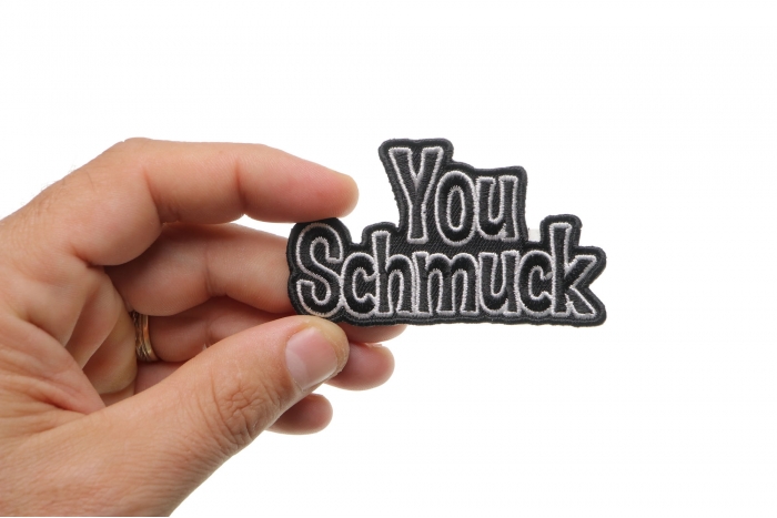 You Schmuck Funny Iron on Patch shown on hand for size comparison