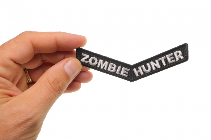 Zombie Hunter Funny Iron on Patch shown on hand for size comparison