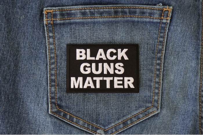 Black Guns Matter Funny Iron on Patch shown on jeans