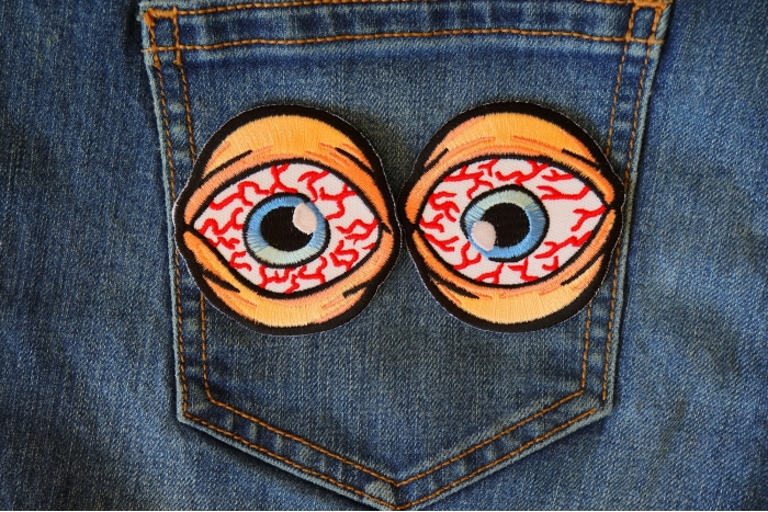 Bloodshot Eyes Funny Iron on Patch shown on jeans