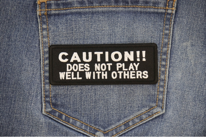 Caution Does Not Play Well With Others Funny Iron on Patch shown on jeans
