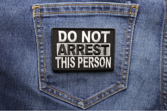 Do Not Arrest This Person Funny Iron on Patch shown on jeans