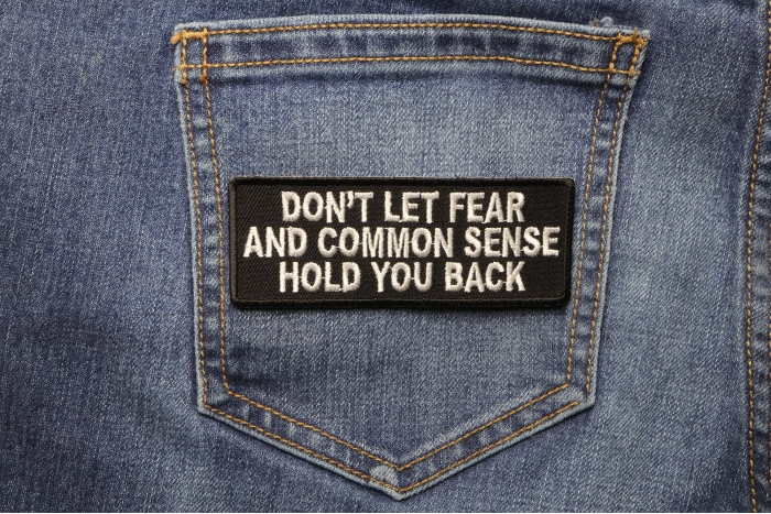 Don't Let Fear and Common Sense Hold You Back Funny Iron on Patch shown on jeans