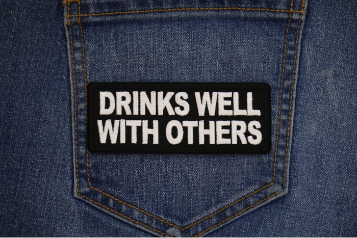 Drinks Well with Others Patch shown on jeans