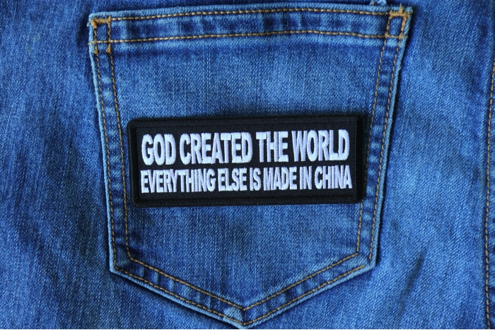 God Created the World Everything Else is Made in China Funny Iron on Patch shown on jeans