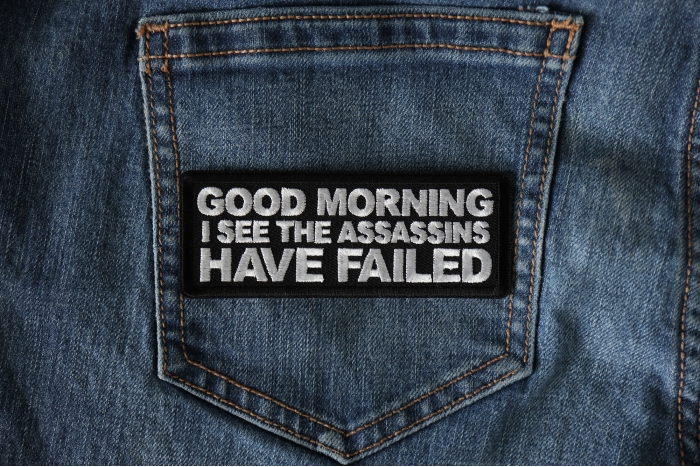 Good Morning I see the assassins have failed Funny Iron on Patch shown on jeans