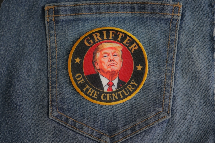Grifter Of The Century Trump Patch shown on jeans