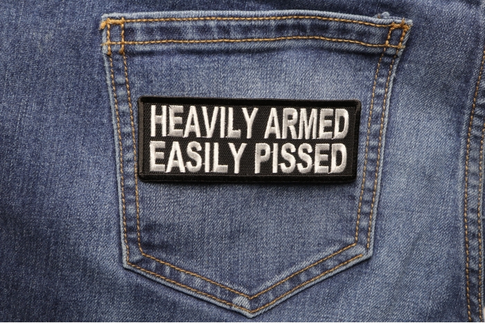 Heavily Armed Easily Pissed Funny Iron on Patch shown on jeans