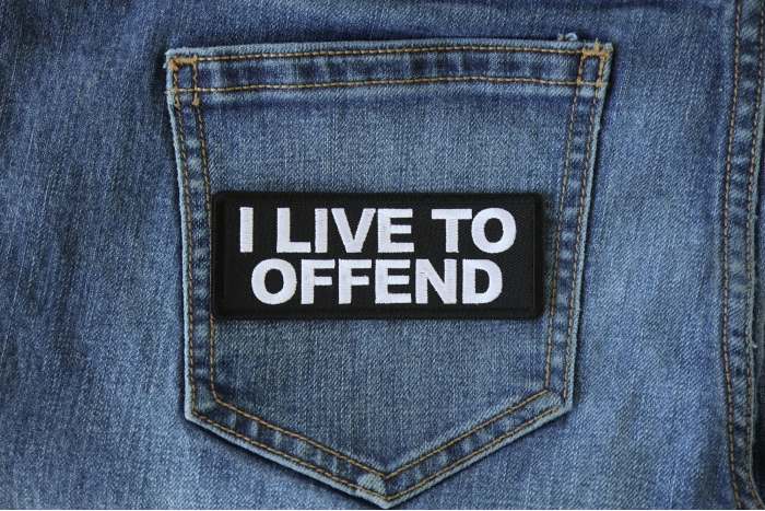 I live to Offend Funny Iron on Patch shown on jeans
